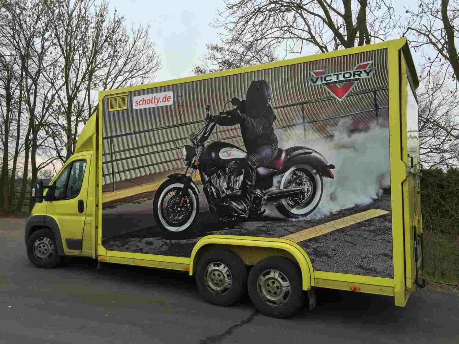 Motorrad auf gelbem Lkw